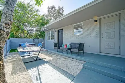 a porch of a house with chairs and a door at Wynwood Bungalow Hottub & Pking in Miami