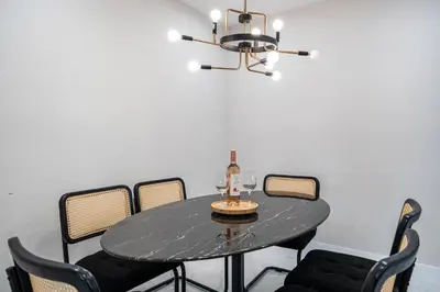 a dining room table with chairs and a chandelier at 4 Bedroom Holiday Retreat BBQ Marketplace in Miami