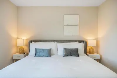 a bedroom with a large white bed with two lamps at 4 Bedroom Holiday Retreat BBQ Marketplace in Miami