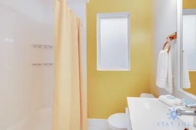 a bathroom with a shower curtain and a sink at Hollywood Broadwalk Haven - Free Parking in Hollywood