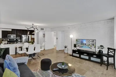 a living room with a couch and a dining room at Superb Private unit Perfectly Located In Brickell in Miami