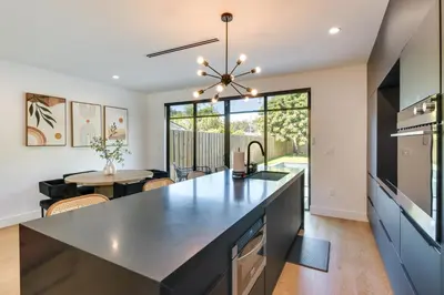 a kitchen with a large island and a dining room at Modern Miami Home with Pool 1 Mi to Design District! in Miami