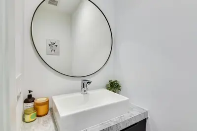 a bathroom with a white sink and a mirror at Modern Miami Home with Pool 1 Mi to Design District! in Miami