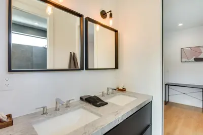 a bathroom with two sinks and two mirrors at Modern Miami Home with Pool 1 Mi to Design District! in Miami