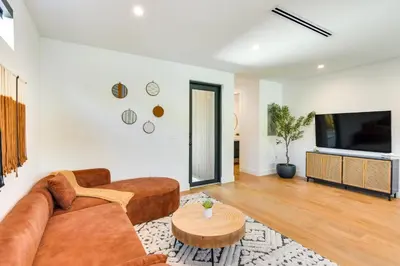 a living room with a couch and a table at Modern Miami Home with Pool 1 Mi to Design District! in Miami