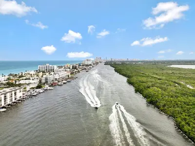 a boat on a river with a city in the background at Magical Beachfront King Escape in Hollywood