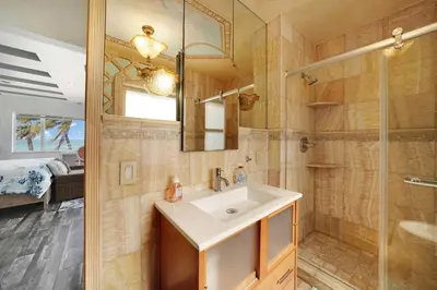 a bathroom with a sink and a shower at Magical Beachfront King Escape in Hollywood