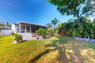 a house with a yard in front of it at Hallandale Hideaway in Hallandale Beach