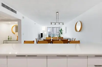 a dining room with a table and chairs at Spacious Family Escape with Pool & Beach Access in Sunny Isles Beach