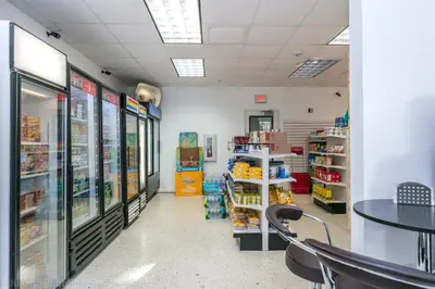 a aisle of a store with a table and chairs at Spacious Family Escape with Pool & Beach Access in Sunny Isles Beach