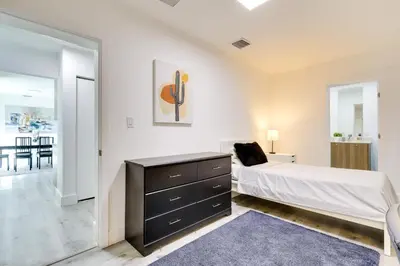 a bedroom with a bed and a dresser at Spacious and Serene Miami Home Walk to Metrorail! in Miami