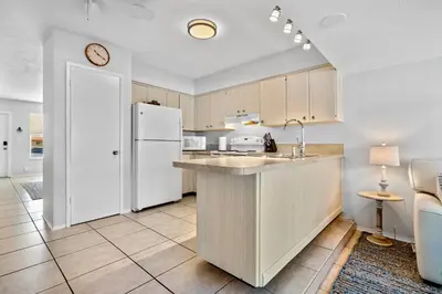 a kitchen with a white refrigerator and a counter at Citrus Isles Waterfront Home in Fort Lauderdale