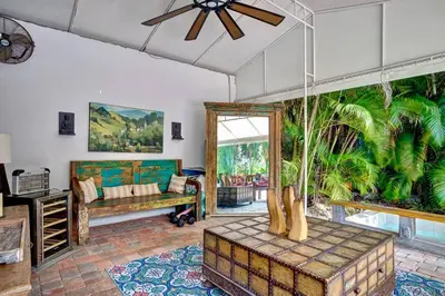 a living room with a couch and a ceiling fan at Breathtaking Pool Home and Backyard by Wilton Mnrs in Fort Lauderdale