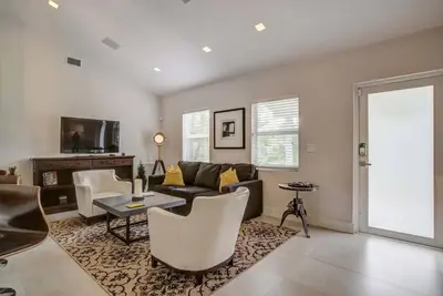 a living room with a couch and a table at Breathtaking Pool Home and Backyard by Wilton Mnrs in Fort Lauderdale