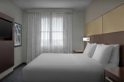 a large white bed in a hotel room with a window at Residence Inn by Marriott Fort Lauderdale Airport & Cruise Port in Dania Beach