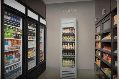 a drink refrigerator in a grocery store with drinks at Residence Inn by Marriott Fort Lauderdale Airport & Cruise Port in Dania Beach