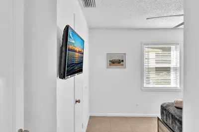 a living room with a flat screen tv on a white wall at 3 Bedroom Villa In F Lauderdale Casino & Beach in Fort Lauderdale