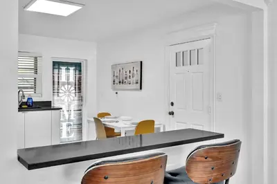 a kitchen with a counter and a table and chairs at 3 Bedroom Villa In F Lauderdale Casino & Beach in Fort Lauderdale