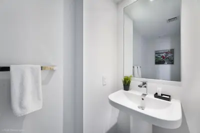 a white bathroom with a sink and a mirror at Breathtaking 35th Floor 1 BDR in Hyde Beach House in Hollywood