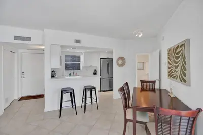 a kitchen and dining room with a table and chairs at Fort Lauderdale Yacht & Beach Club 412 in Fort Lauderdale