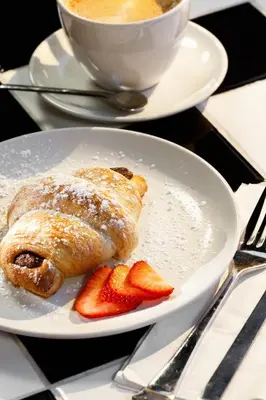a plate with a pastry and strawberries on a table at Moxy Miami Wynwood in Miami
