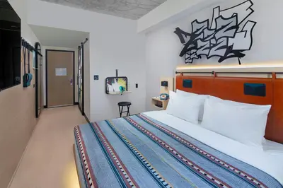 a hotel room with a bed and a television at Moxy Miami Wynwood in Miami