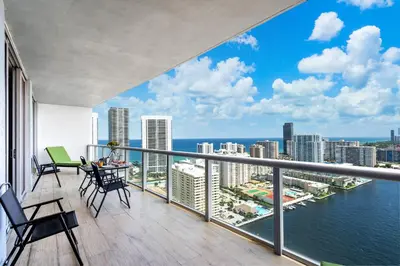a balcony with a view of the ocean and buildings at Ocean Views - Pool & Gym - Pet Friendly - Close to Beach in Hallandale Beach