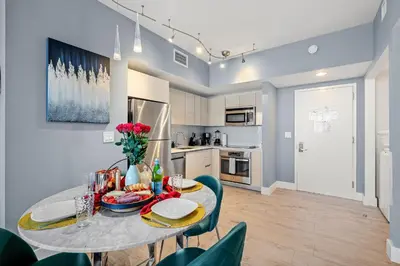 a kitchen and dining room with a table and chairs at Ocean Views - Pool & Gym - Pet Friendly - Close to Beach in Hallandale Beach