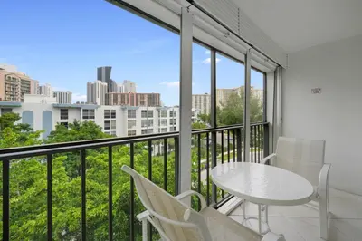a balcony with a table and chairs and a view of the city at Le Cartier Sunny Isles Ocean Paradise in Sunny Isles Beach