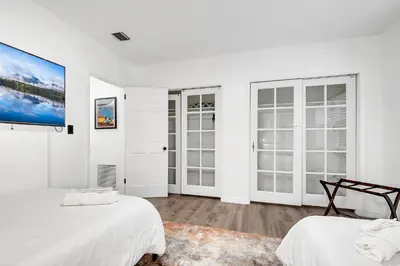 a white room with two beds and windows at Casa Linda Gated 3 bed 2 bath by the River 1810 in Miami