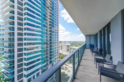 a balcony of a building with chairs and tables at Unwind in Your Amazing City View Apartment in Miami