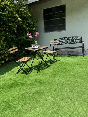 a table and two chairs and a bench in a yard at Beds & Sheets DOWNTOWN in Miami