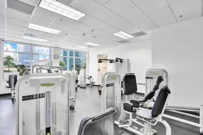 a gym with a row of chairs and machines at Miami Brickell 3 Bedrooms high ceiling loft in Miami