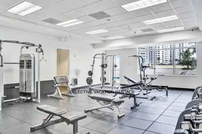 a gym with several tread machines in a room at Miami Brickell 3 Bedrooms high ceiling loft in Miami