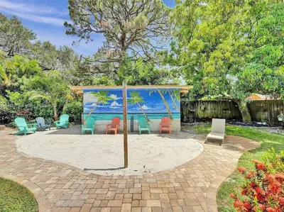 a patio with chairs and a painting of the ocean at Tropical Oasis - BBQ and Beach-Inspired Nook in Fort Lauderdale