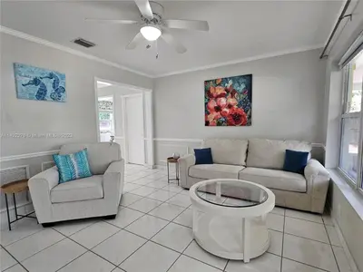 a living room with two couches and a ceiling fan at Tropical Oasis - BBQ and Beach-Inspired Nook in Fort Lauderdale
