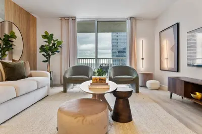 a living room with a couch and a table at Cloud 9 - Amenities 24 7 Security & Location in Miami