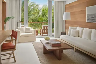 a living room with a white couch and a table at The Miami Beach EDITION in Miami Beach