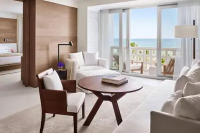 a living room with a couch and a table at The Miami Beach EDITION in Miami Beach