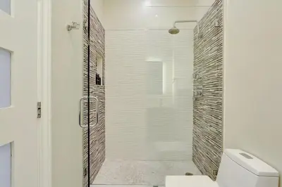 a shower with a glass door in a bathroom at Brickell Oasis 5BR Free Parking Pool Gym and More in Miami