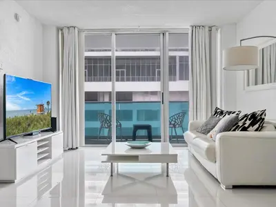 a living room with a white couch and a tv at Ocean View 1 bed Sian 11th floor Miami in Hollywood