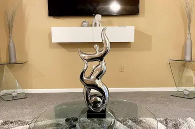 a metal sculpture on a glass table in a room at Luxury Miami 2br Townhouse Near Stadium !! in Miami Gardens