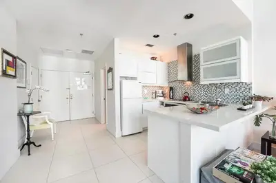 a kitchen with white cabinets and a counter top at Castle Ph11 Penthouse with Balcony, Free Parking, Pool, Tennis, Beach Access in Miami Beach