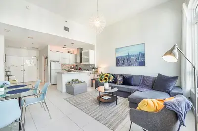 a living room with a couch and a table at Castle Ph11 Penthouse with Balcony, Free Parking, Pool, Tennis, Beach Access in Miami Beach