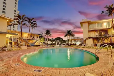 a swimming pool in the middle of a resort at Vistamar Waterfront Beach Abode -Walk to the Beach in Fort Lauderdale
