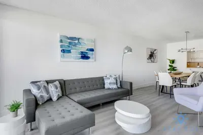 a living room with a couch and a table at Beachside Bliss: 1BR Retreat Amenities in Sunny Isles Beach
