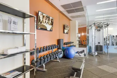 a gym with a bunch of dumbbells on the wall at 5th Floor Luxury Suite at Trump Int Resort in Sunny Isles Beach