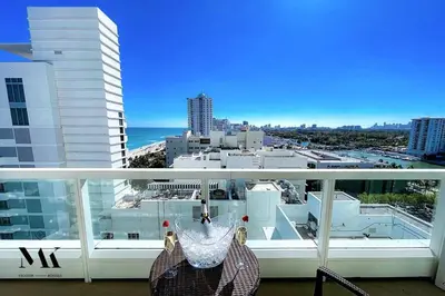 a balcony with a view of a city at FontaineBleau Resort Balcony w Ocean + Bay View in Miami Beach