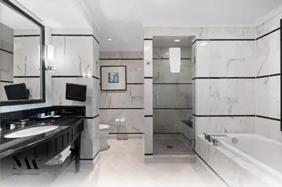 a bathroom with a sink and a tub and a toilet at FontaineBleau Resort Balcony w Ocean + Bay View in Miami Beach