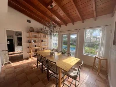a dining room with a wooden table and chairs at Villa Rustica 5 Bedroom 3 Bath with Pool Next to River 1800 in Miami